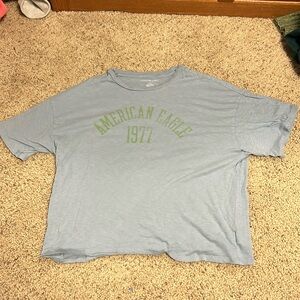 This T-shirt is from American eagle, it’s a size L, and it’s blue